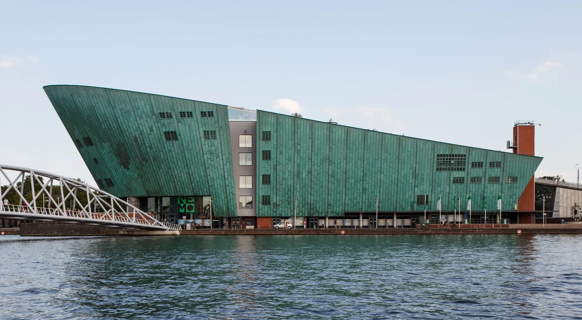 Het kopergroene, scheepsvormige gebouw van NEMO aan het water.