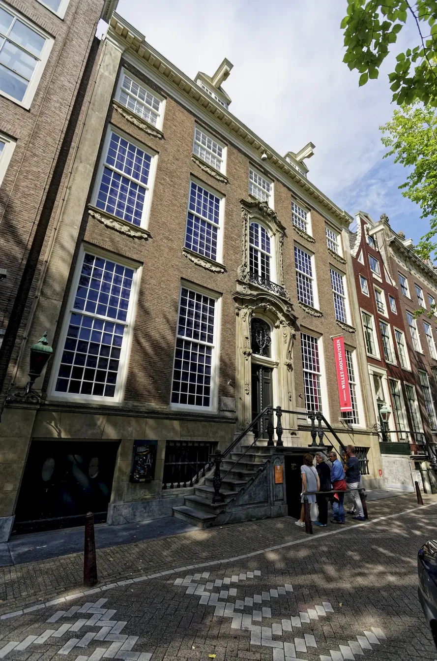 Large maison de canal aux hautes fenêtres, avec une entrée en pierre et une enseigne du Museum Willet-Holthuysen.