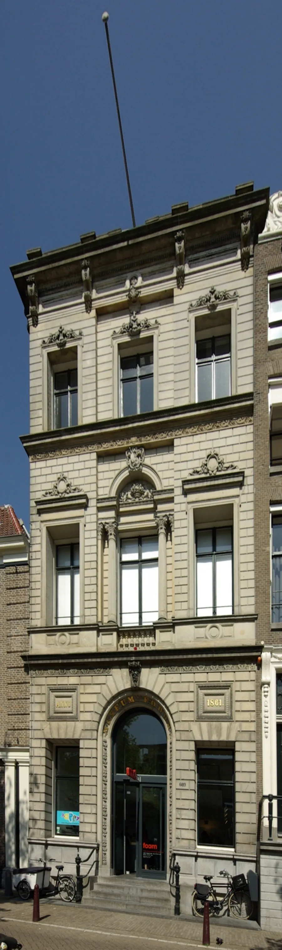Light-coloured facade of Foam with bicycles outside the entrance.